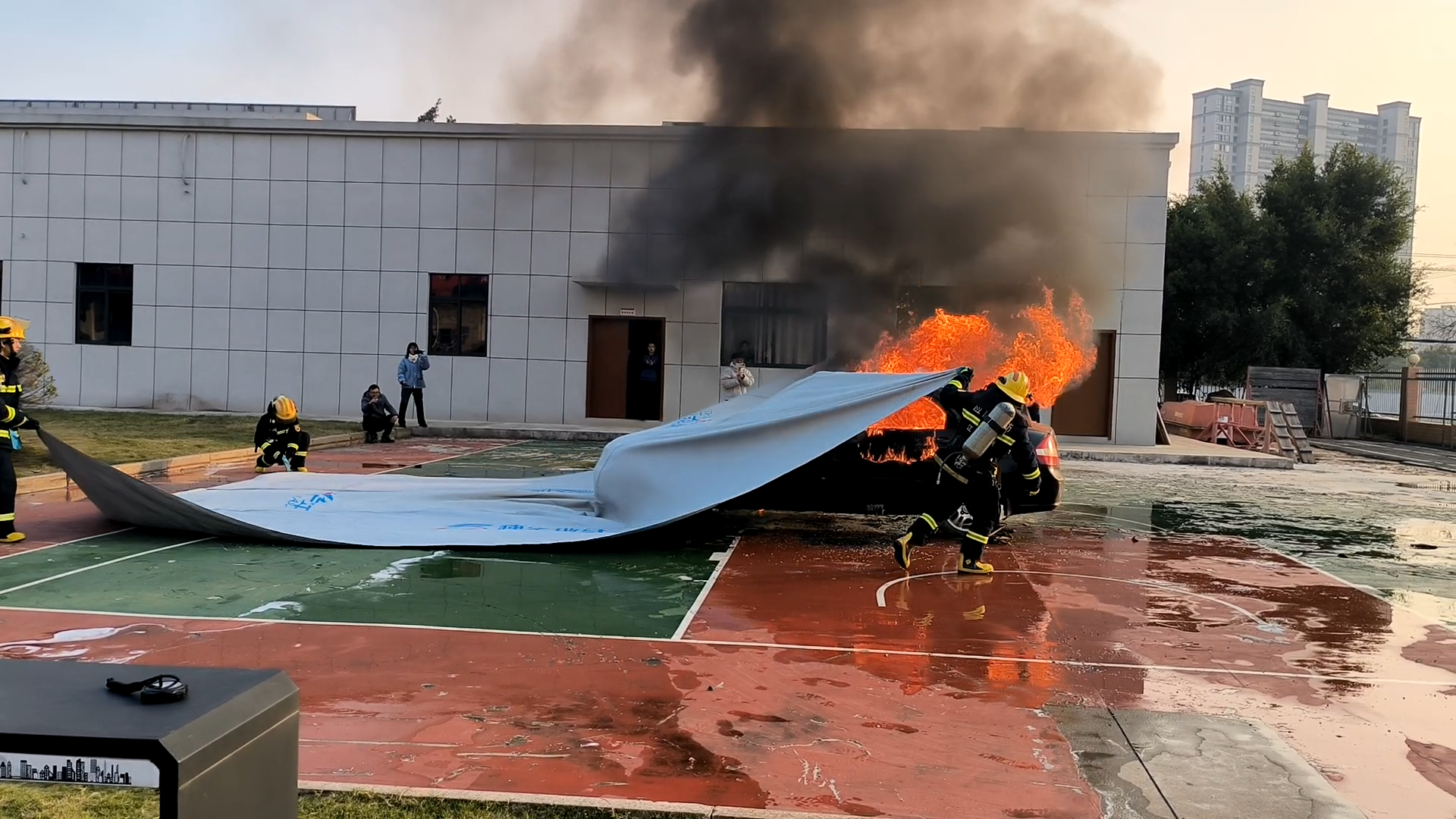 Firefighters used a vehicle fire blanket to extinguish a burning car