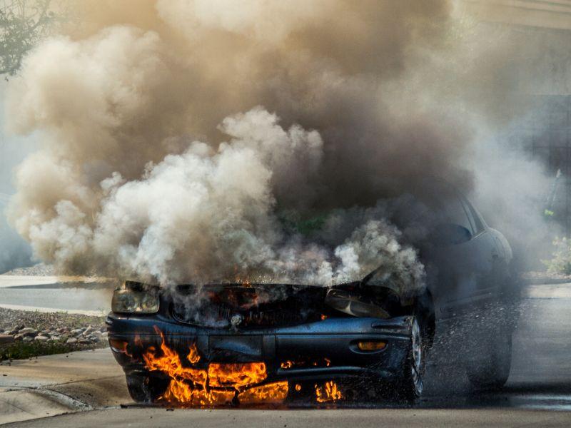 Burning vehicle with heavy smoke showing the importance of car fire protection and emergency fire safety solutions